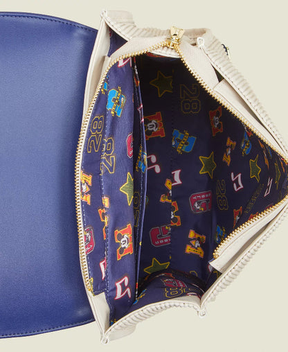 Open blue and white handbag revealing a colorful patterned interior.