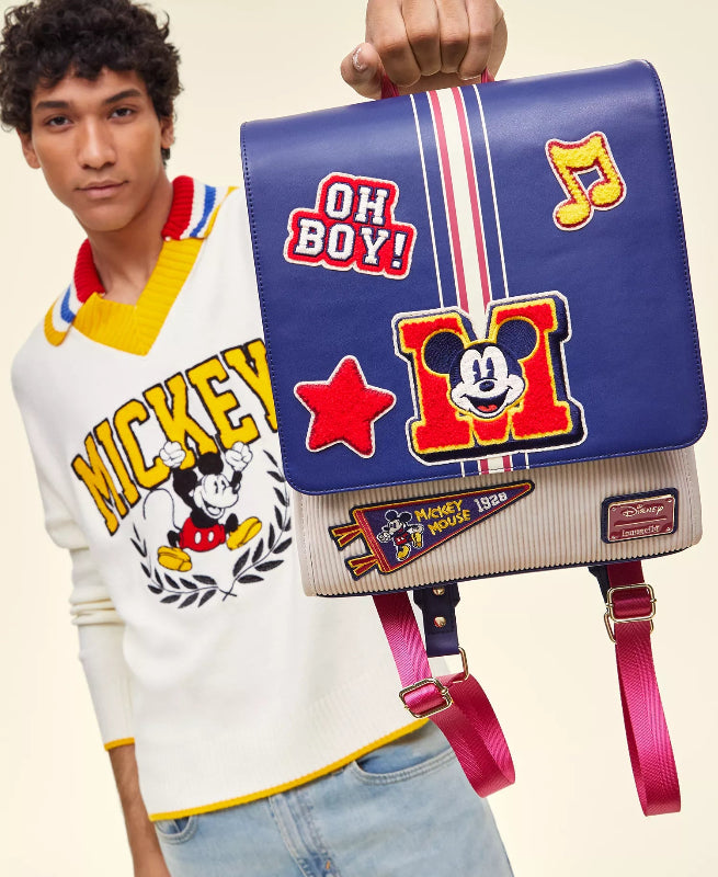 Person wearing a Mickey Mouse-themed sweater with a matching bag featuring Disney characters.