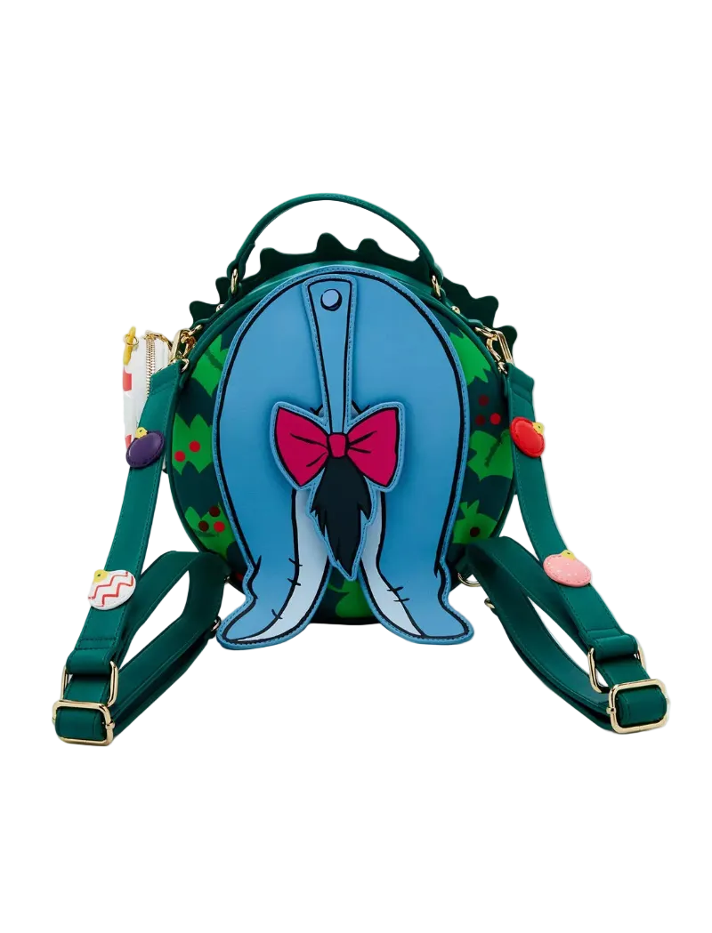 A green and blue Whimsical Wicked Bag backpack featuring a 3D blue whale tail design with a pink bow on the front, set against a plain white background.