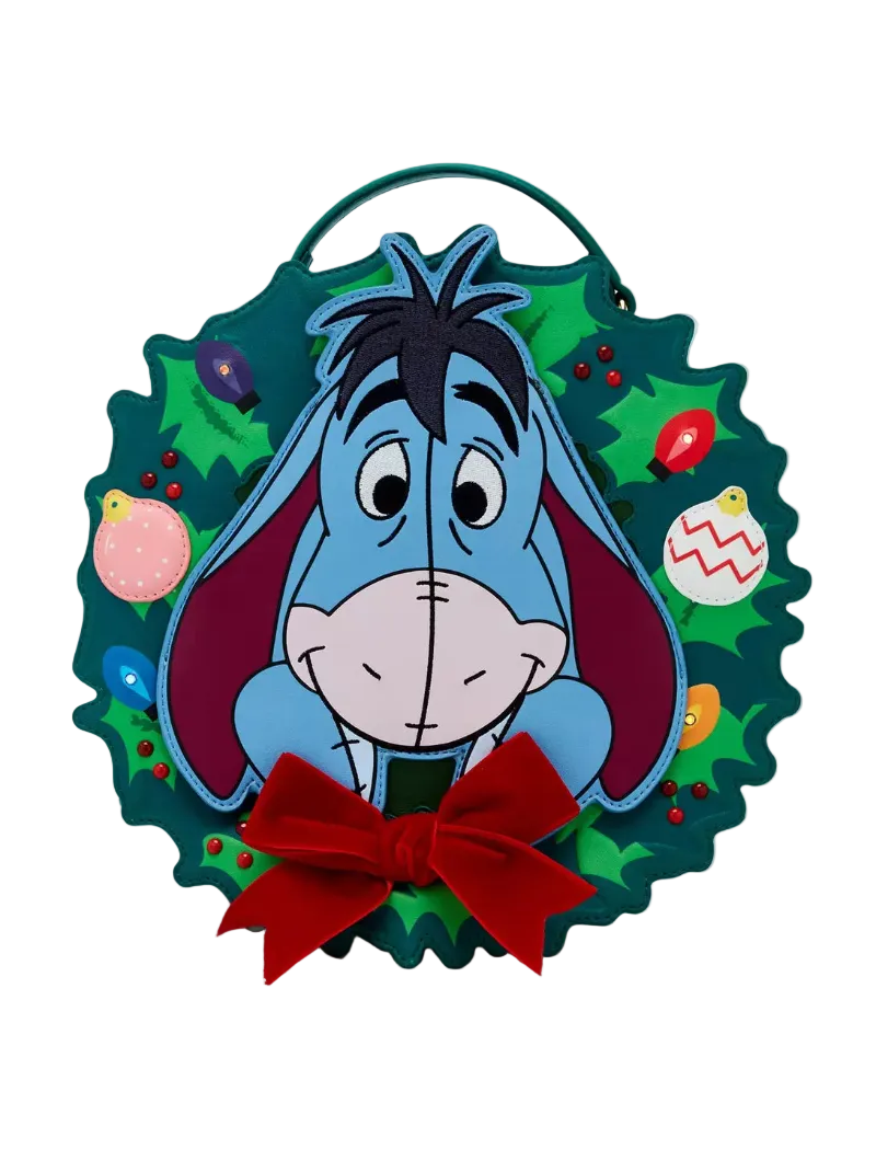 A circular Christmas wreath wall hanging featuring the character Eeyore from Winnie the Pooh, with a red bow at the bottom and colorful ornaments on a white background.
