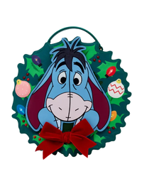 A circular Christmas wreath wall hanging featuring the character Eeyore from Winnie the Pooh, with a red bow at the bottom and colorful ornaments on a white background.