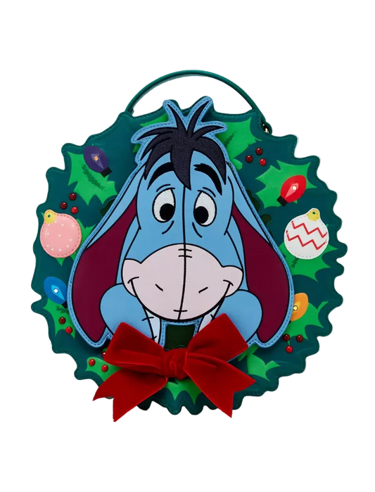 A circular Christmas wreath wall hanging featuring the character Eeyore from Winnie the Pooh, with a red bow at the bottom and colorful ornaments on a white background.