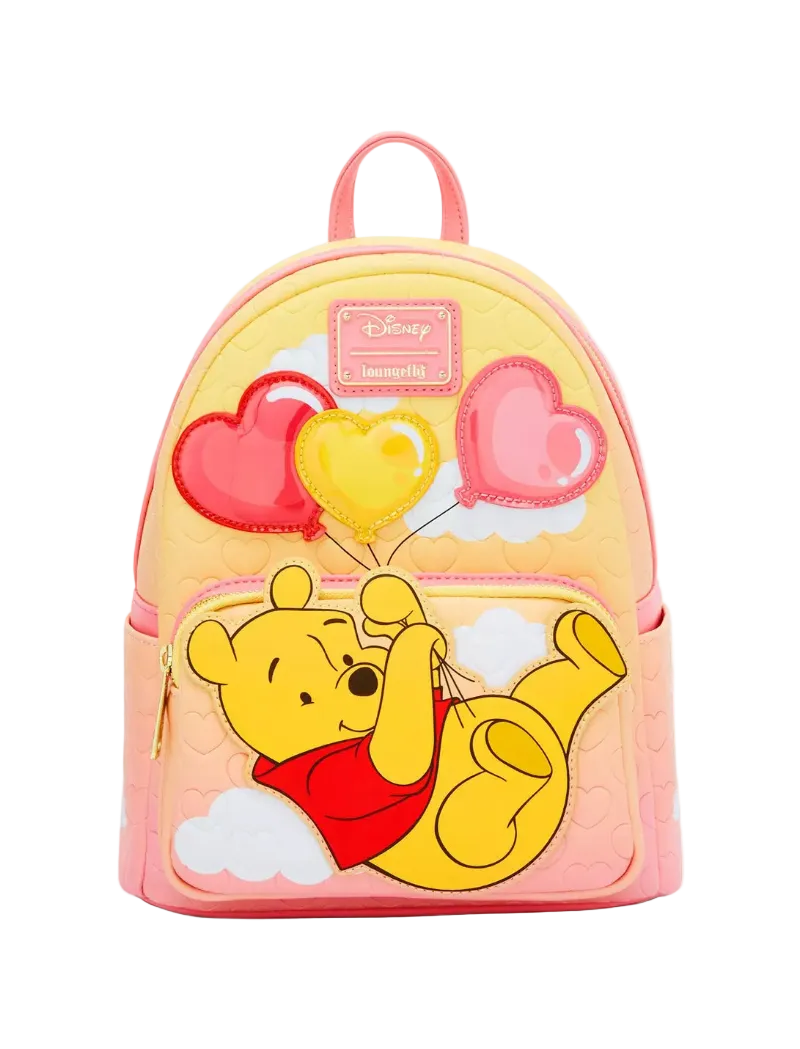 A pastel pink and yellow Disney Winnie the Pooh backpack featuring a large applique of Winnie the Pooh holding red and yellow heart-shaped balloons, with a pink Disney Memory Lane patch on the front.