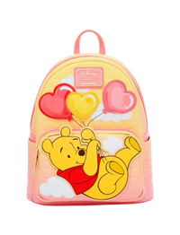 A pastel pink and yellow Disney Winnie the Pooh backpack featuring a large applique of Winnie the Pooh holding red and yellow heart-shaped balloons, with a pink Disney Memory Lane patch on the front.