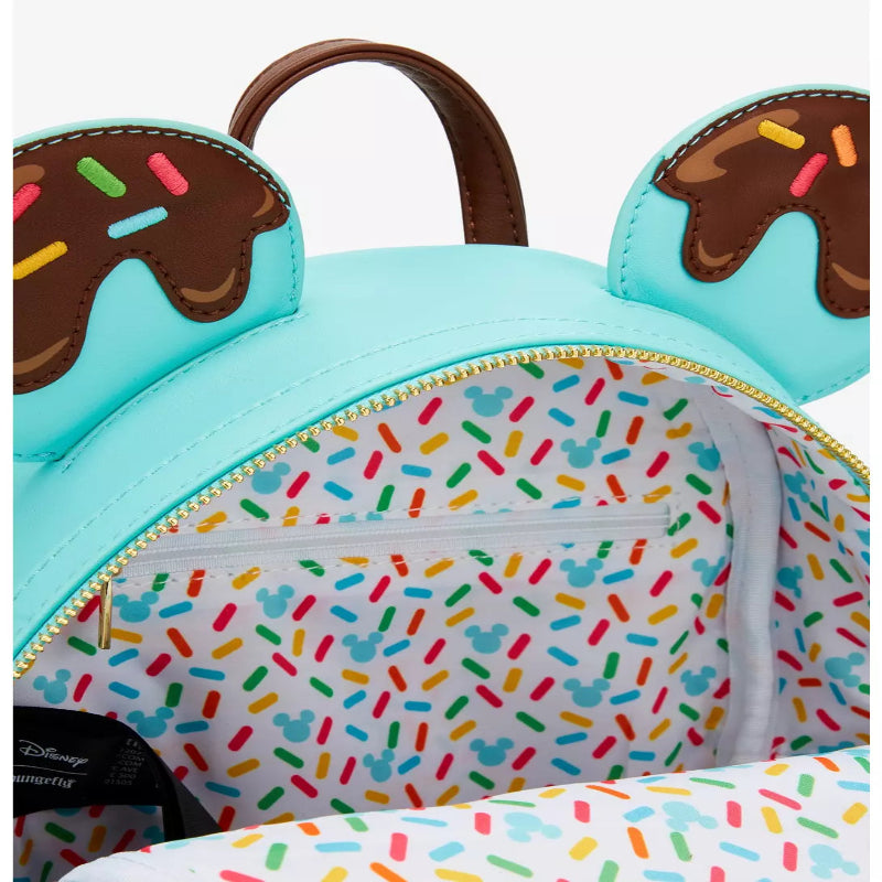 Light blue backpack with donut design and colorful sprinkles on a white background