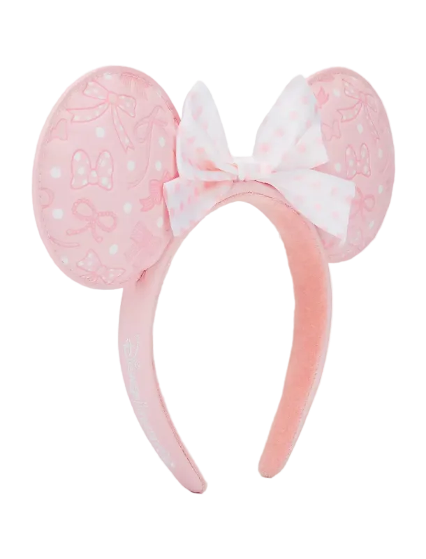 A pink plush headband featuring round mouse ears with bow and polka dot patterns, and a matching bow on the front, shown against a plain white background.
