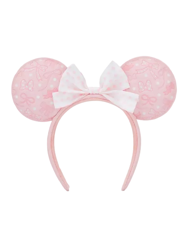 A pink and white Minnie Mouse-themed headband with round ears featuring a subtle bow pattern and a central white bow with pink polka dots, shown against a plain white background.