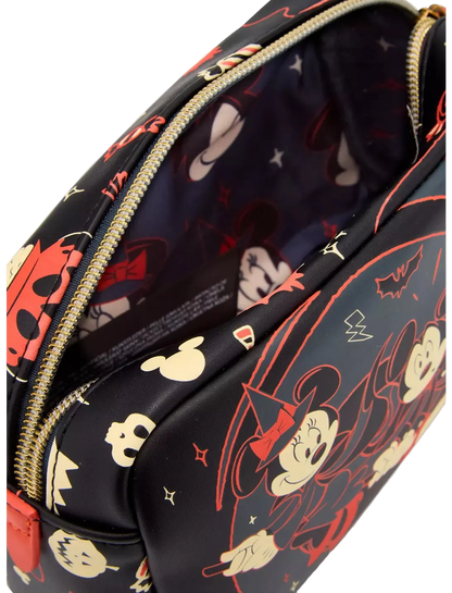 A close-up of a black zippered cosmetic pouch featuring a colorful cartoon character print in red, beige, and white, with a gold zipper.