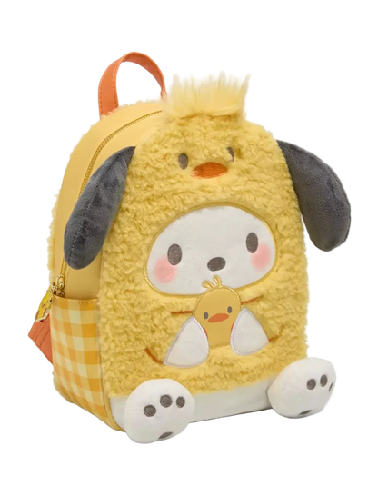 A yellow plush dog character backpack with a fuzzy textured body, featuring a cartoon dog face on the front, white paws, dark gray floppy ears, and a yellow-and-white gingham side pocket, shown on a light gray background.