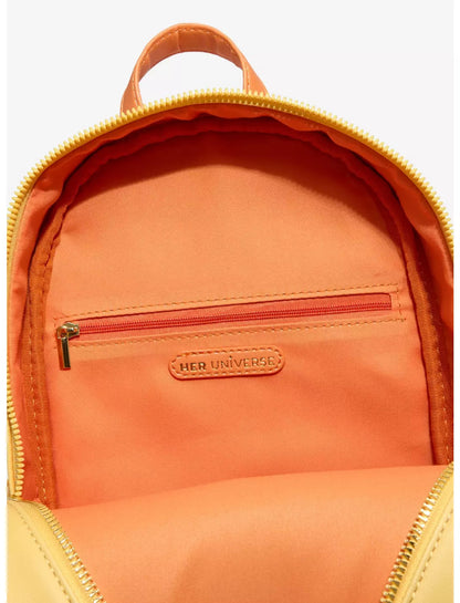 Close-up of the interior of a backpack showing a bright orange fabric lining, a zippered pocket with a red zipper, and a small tan leather brand patch that reads HER UNIVERSE.