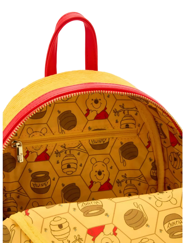 Yellow backpack with red zipper and Winnie the Pooh pattern on a white background