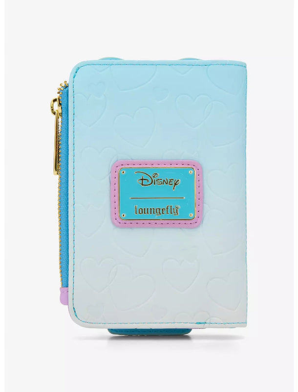 A light blue and white gradient Loungefly Disney wallet featuring an embossed heart pattern, a pink-bordered Disney Loungefly patch, and a gold zipper.
