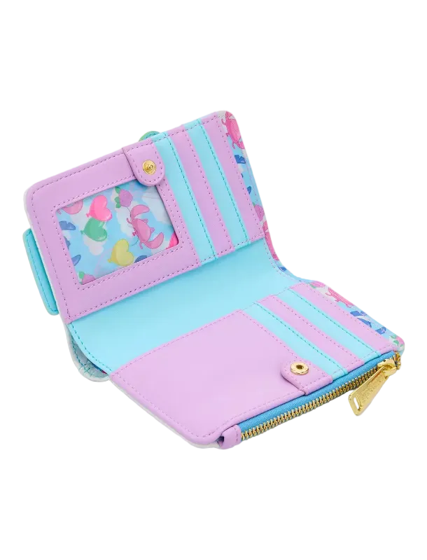 A pastel-colored bi-fold wallet shown open, featuring light purple, light blue, and pink panels, a heart-patterned ID window, and gold-tone hardware.