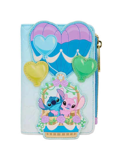 A light blue faux-leather wallet featuring a hot air balloon and heart design, with a front patch depicting Stitch and Angel in a basket, and a gold zipper pull.