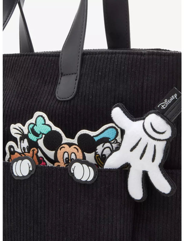 Black tote bag with Disney character patches on a white background