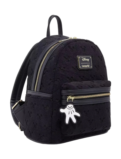 Black backpack with gold zippers and a Mickey Mouse charm on a white background