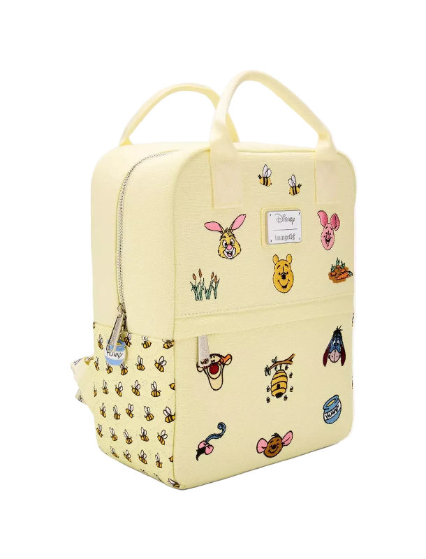 Yellow backpack with various cartoon character stickers on a white background