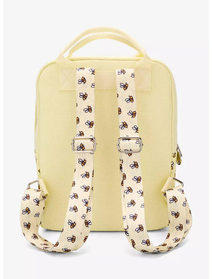 Yellow backpack with patterned straps on a white background