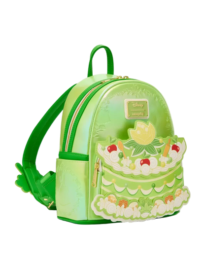 Green cake-shaped backpack with decorative elements on a white background