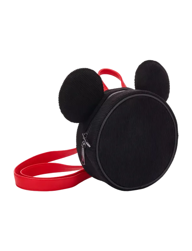 A black corduroy Mickey Mouse-shaped backpack with a bright red strap and top handle, shown on a clean white background.