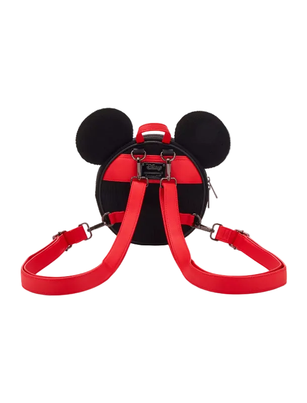 A red and black Mickey Mouse-shaped backpack with black ears and a red shoulder strap, shown from the back on a light gray background.