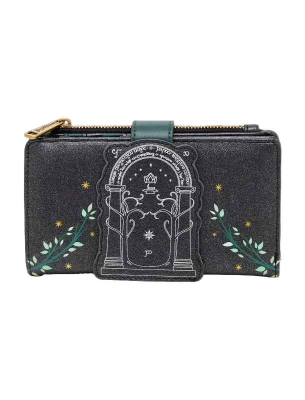 A black glittery zip-around wallet featuring a central tombstone graphic with a star and moon design, flanked by green leafy vines and small gold stars, with a gold zipper pull.