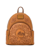 A tan leather mini backpack featuring an embossed Day of the Dead design with a central skeleton face, skulls, guitars, and floral patterns. The backpack has a top handle, zippered main compartment, side pockets, and a gold-tone metal brand plaque on the front.