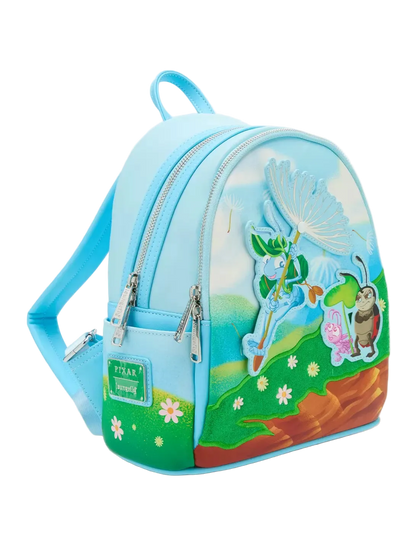 A light blue faux-leather mini backpack featuring a whimsical outdoor scene with raised 3D elements of a dandelion, a pink ladybug, a brown beetle, and green hills, shown on a white background.