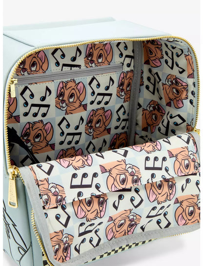 A light blue zippered bag shown open, revealing a patterned interior with a matching flap pocket. The fabric features a repeating print of a cartoon dog face with pink ears and black musical notes on a pale blue background, with gold-tone zippers.