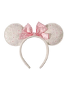 A Minnie Mouse-inspired headband with round ears covered in a light beige and pink Disney-themed pattern, featuring a large pink polka-dot bow on a white background.