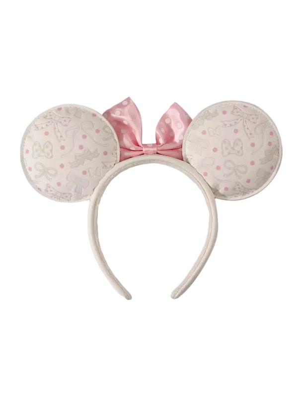 A headband with large round mouse ears in a light pink and white patterned fabric, featuring a pink satin bow on top, shown against a plain white background.