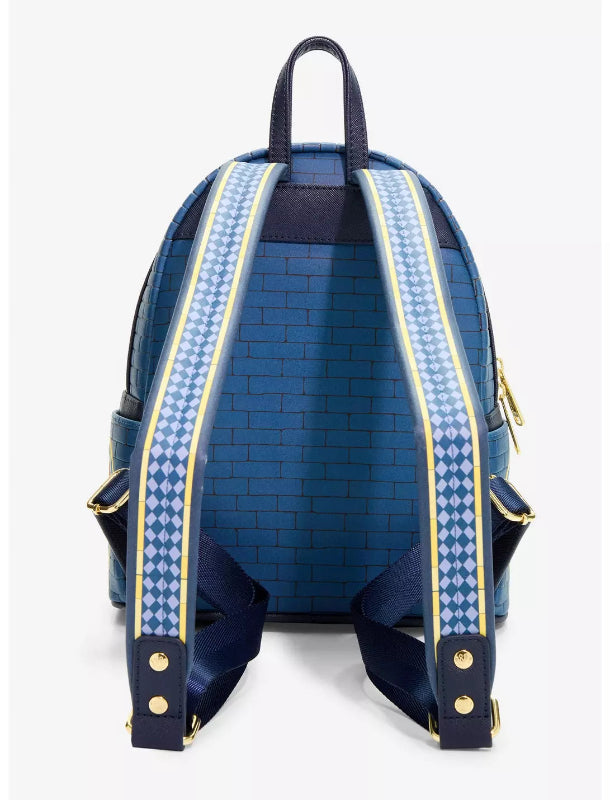 A blue brick-patterned backpack shown from the back, featuring navy blue shoulder straps with a light blue and white diamond pattern and gold-tone hardware.