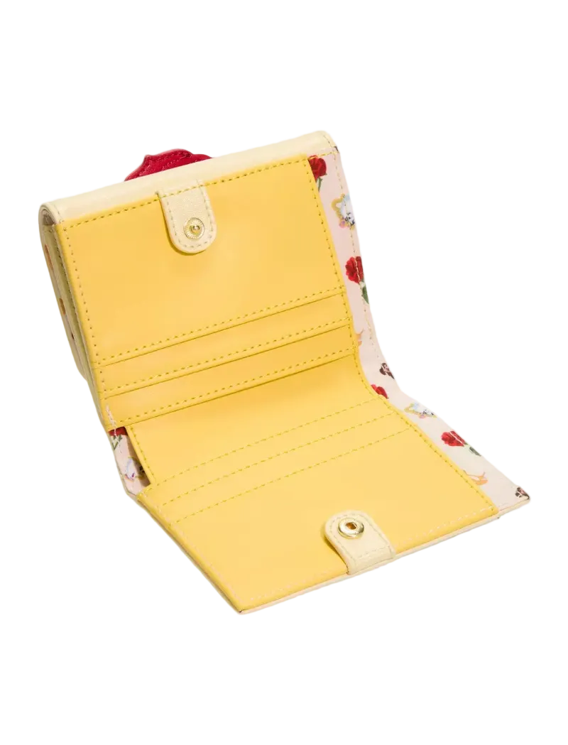 A yellow bifold wallet shown open, featuring a smooth yellow exterior, cream-colored snap-button tabs, and a floral patterned interior lining with red and green accents.