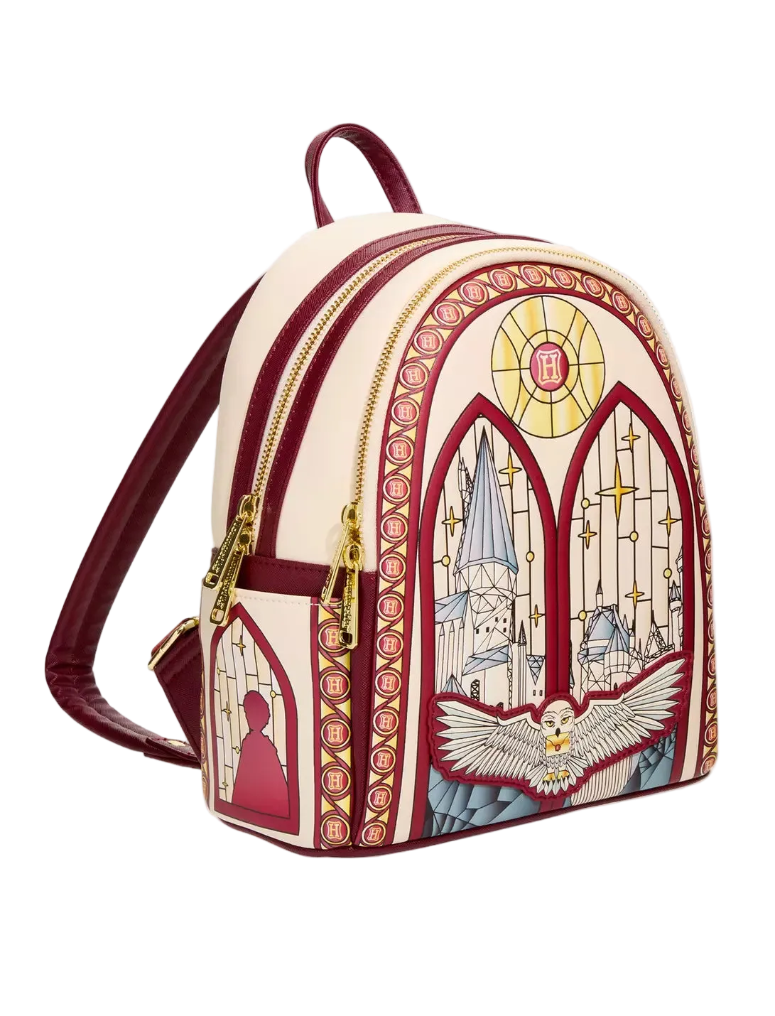 A small backpack with a cream and burgundy design inspired by stained glass, featuring gold zippers and a printed illustration of a cathedral, a dove, and a silhouette.