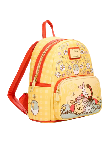A yellow and orange Disney-themed mini backpack featuring Winnie the Pooh characters on the front pocket, set against a plain white background.