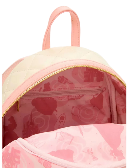 Close-up of a pink and cream quilted backpack with a gold zipper, showing the interior lined with a pink Paris-themed pattern.
