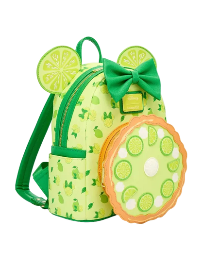 A lime-themed mini backpack with a matching round zippered pouch, featuring a green bow, mouse ears with lime slice designs, and a pie-crust-look border on the pouch, shown on a light gray background.