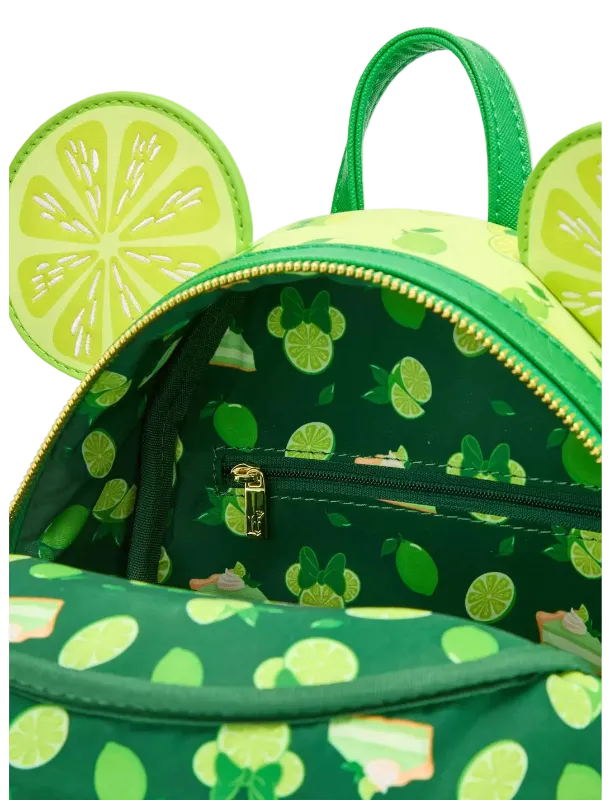 A green and lime-patterned backpack with mouse-ear cutouts and a green handle, shown open to reveal a matching printed interior lining with a gold zipper.