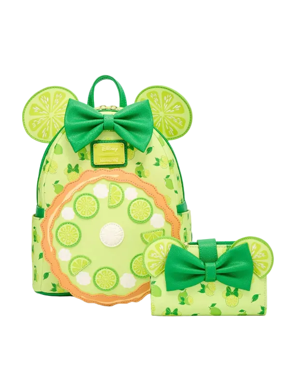 A lime-green backpack and matching wallet set with Minnie Mouse-inspired ears, green bows, and a citrus slice pattern on a light gray background.