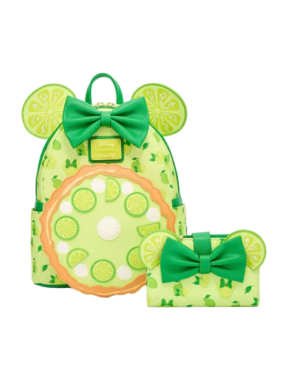 A lime-green backpack and matching wallet set with Minnie Mouse-inspired ears, green bows, and a citrus slice pattern on a light gray background.