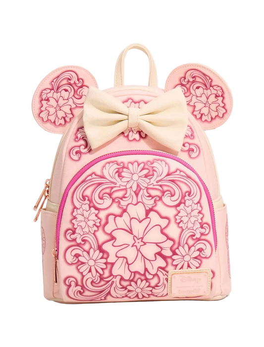 A pink mini backpack featuring embossed floral patterns, a large cream bow on top, and mouse-ear cutouts on the sides, shown against a plain white background.