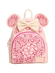 A pink mini backpack featuring embossed floral patterns, a large cream bow on top, and mouse-ear cutouts on the sides, shown against a plain white background.