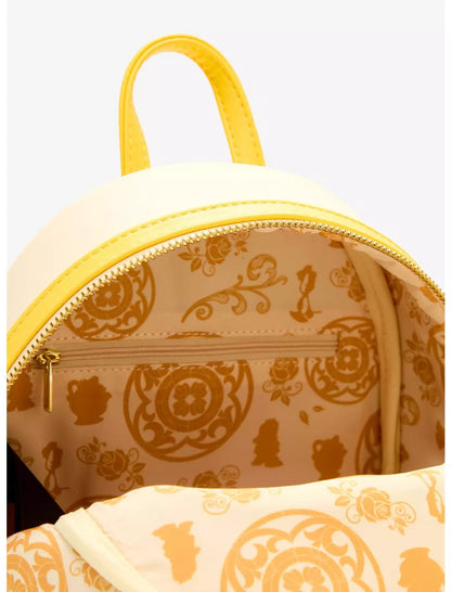 Close-up of a small backpack with a cream exterior, bright yellow trim, and a gold-toned interior pattern featuring Disney characters and floral motifs.