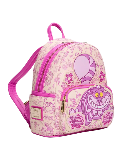 A pink and purple patterned mini backpack featuring a large Cheshire Cat graphic on the front pocket, with a Disney Lounge Series patch on the side pocket.