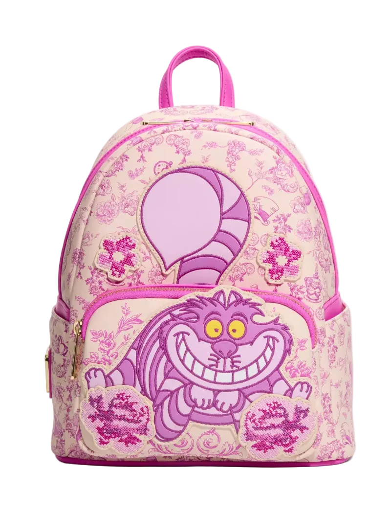 A pink and purple Disney Cheshire Cat backpack with a floral toile pattern, featuring a large Cheshire Cat graphic on the front pocket and a pink top handle, shown against a plain white background.