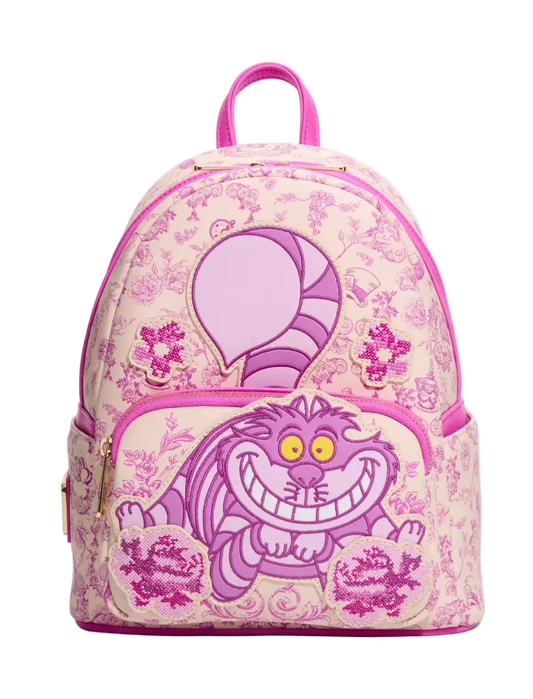A pink and purple Disney Cheshire Cat backpack with a floral toile pattern, featuring a large Cheshire Cat graphic on the front pocket and a pink top handle, shown against a plain white background.