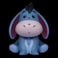 Blue donkey figurine with a bow on a white background