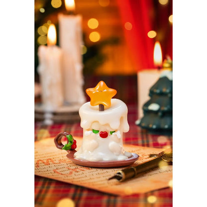 Decorative candle with a star on top on a table with a festive background