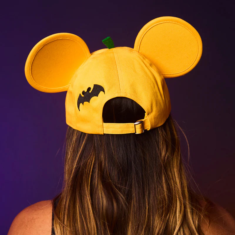 Yellow cap with bat design and ears on a purple background
