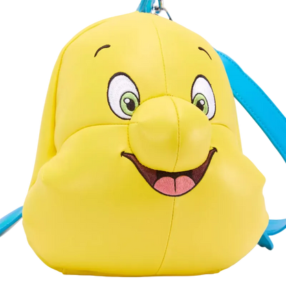A yellow character backpack shaped like a cartoon face, with embroidered eyes, nose, smile, and a bright blue strap visible against a white background.